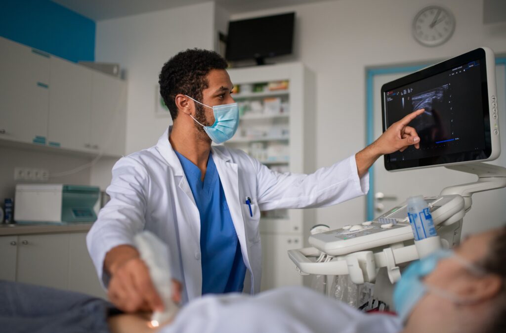 sonographer conducting an ultrasound on a pregnant woman