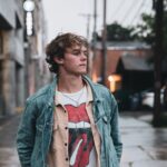 a young man on the street thinking about fatherhood