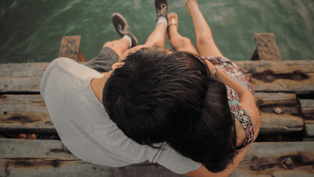 couple sitting on a dock together